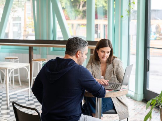 Photo by LinkedIn Sales Solutions man in black long sleeve shirt sitting on chair beside woman in black and white stripe