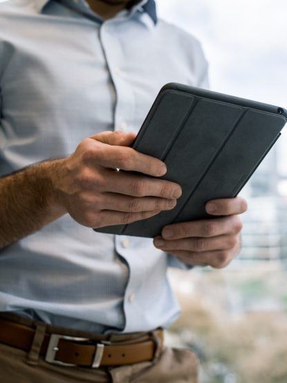 person holding black smart cover during daytime